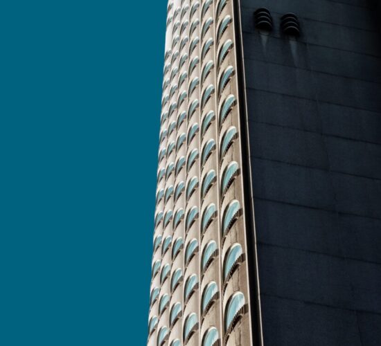Vertical low angle shot of a beautiful skyscraper under the blue sky